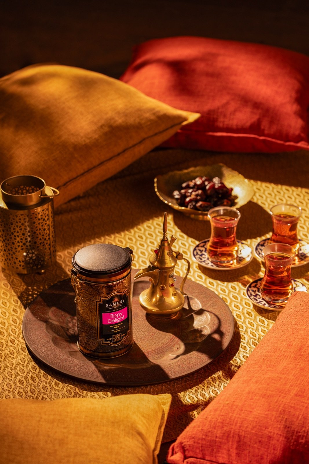 Warm brass tea service with glass cups of freshly brewed tea