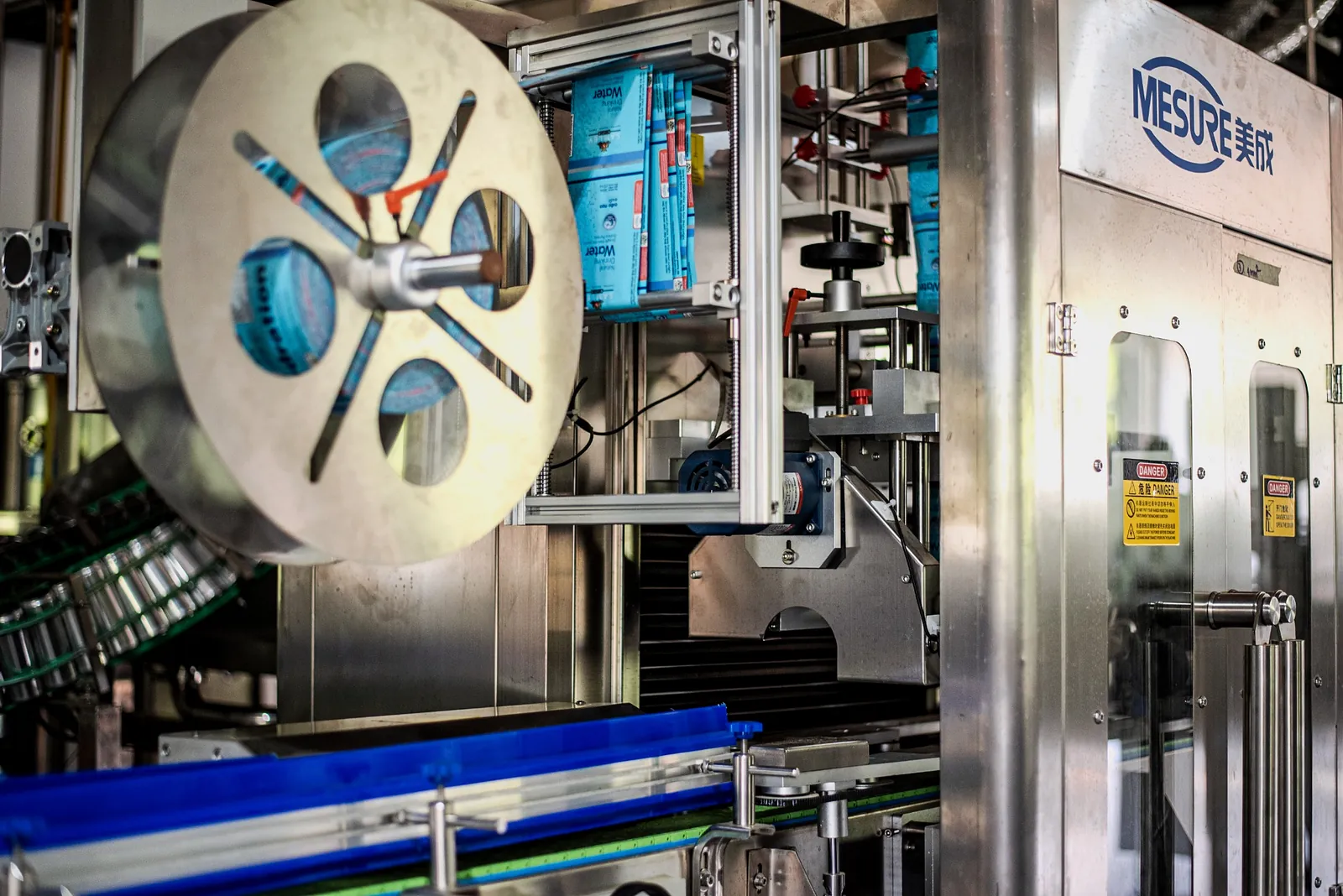 Close view of the can seamer and sleeve reel on the line